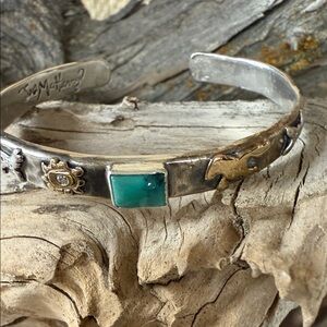 Jes MaHarry “Strong Heart Cuff” with turquoise stone in center.